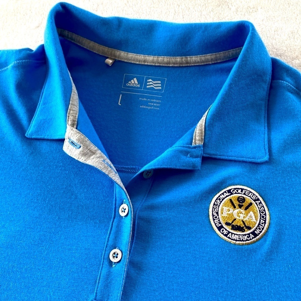 Adidas PGA Women's Blue Golf Polo Shirt. PGA Crest on chest and logo on sleeve.